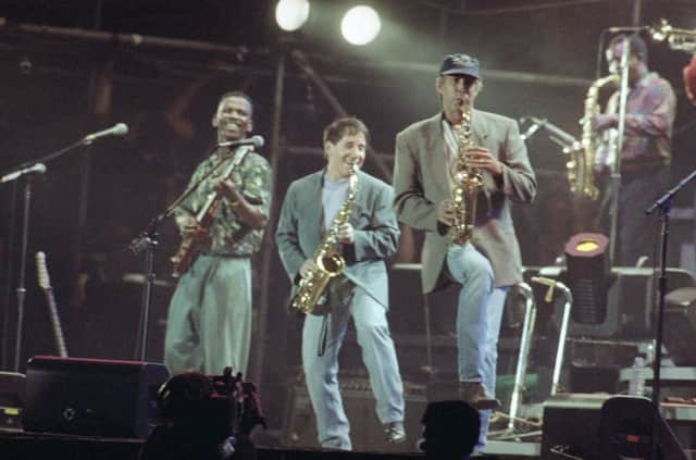 Paul Simon, centre, plays a finale with lead guitarist Ray Phiri, left. Picture: Malcolm Clarke