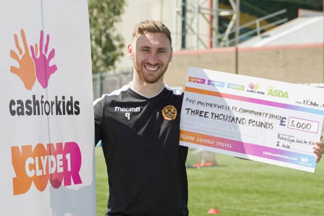 Motherwell's Louis Moult accepts an award from the Radio Clyde Cash for Kids charity. Picture: Craig Foy/SNS
