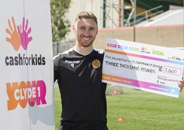 Motherwell's Louis Moult accepts an award from the Radio Clyde Cash for Kids charity. Picture: Craig Foy/SNS