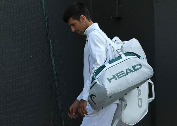 Novak Djokovic leaves the court after retiring from his quarter-final against Tomas Berdych. Picture: Glyn Kirk/AFP/Getty Images