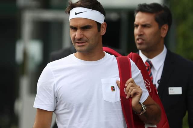 Roger Federer arrives for a practice session ahead of his Wimbledon semi-final match against Czech Republic's Tomas Berdych. Picture: AFP/Getty Images