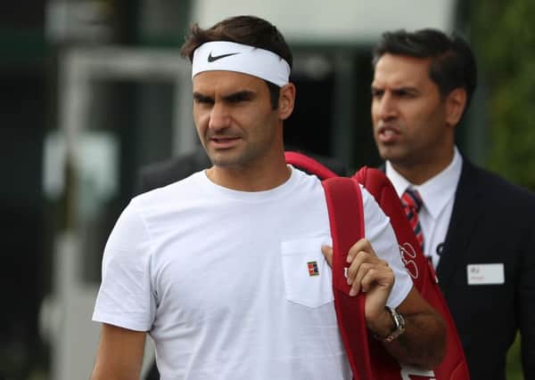 Roger Federer arrives for a practice session ahead of his Wimbledon semi-final match against Czech Republic's Tomas Berdych. Picture: AFP/Getty Images