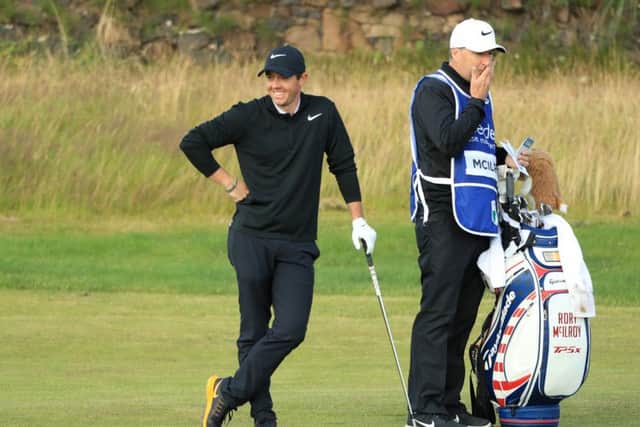 Rory McIlroy has a wry smile after putting his approach into the burn at the 13th at Dundonald Links. Picture: Getty Images
