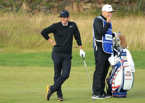 Rory McIlroy has a wry smile after putting his approach into the burn at the 13th at Dundonald Links. Picture: Getty Images