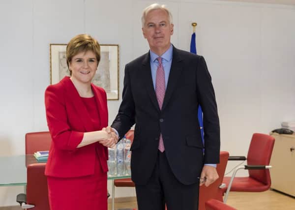 The EU chief Brexit negotiator Michel Barnier, right, welcomes Scottish First Minister Nicola Sturgeon for a meeting at EU headquarters in Brussels. Picture: AP Photo/Geert Vanden Wijngaert