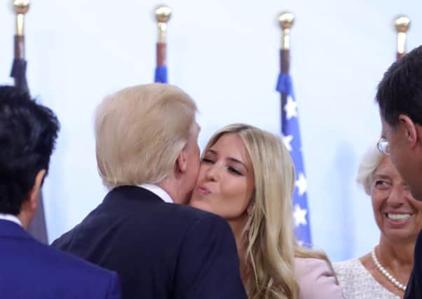 President Donald Trump kisses his daughter Ivanka as they attend a panel discussion during the G20 summit in Hamburg. Picture: Michael Kappeler/Getty
