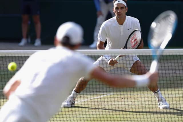 Roger Federer returns against Tomas Berdych during their men's singles semi-final at Wimbledon. Picture: Adrian Dennis/AFP/Getty Images
