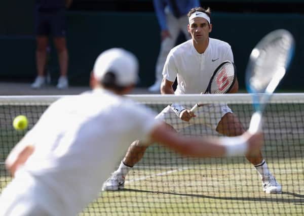 Roger Federer returns against Tomas Berdych during their men's singles semi-final at Wimbledon. Picture: Adrian Dennis/AFP/Getty Images