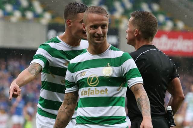 Leigh Griffiths laughs in disbelief after his booking shortly after a glass bottle was thrown at the player. Picture: PA