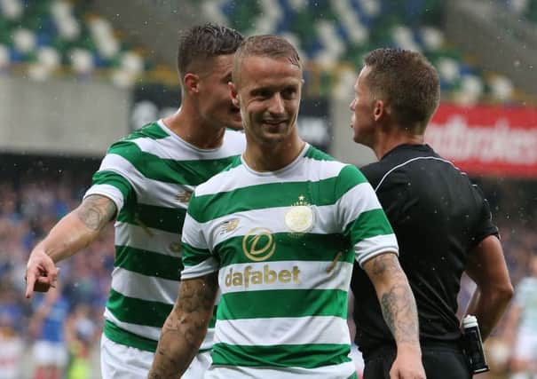 Leigh Griffiths laughs in disbelief after his booking shortly after a glass bottle was thrown at the player. Picture: PA