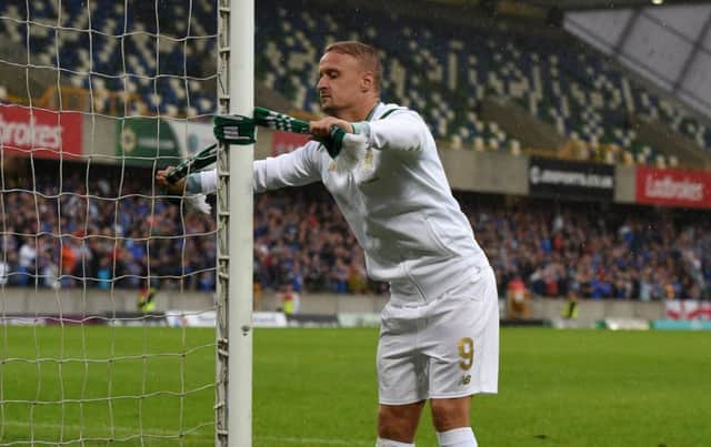 Celtic striker Leigh Griffiths ties a scarf to the goalpost at full-time. Picture: Getty
