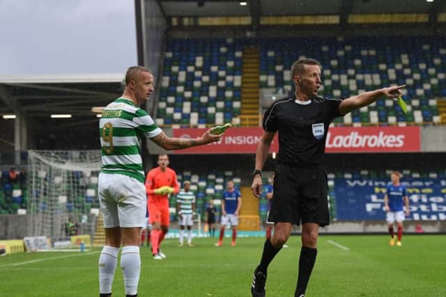 Leigh Griffiths holds the glass bottle thrown in the direction of the striker. Picture: Getty