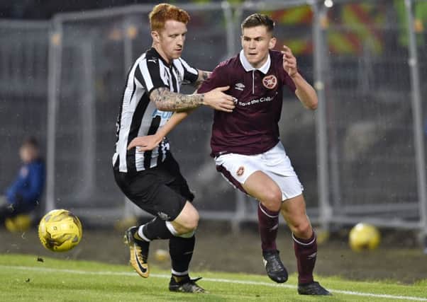 Hearts' Rory Currie skips away from Newcastle's Jack Colback. Picture: Rob Casey/SNS