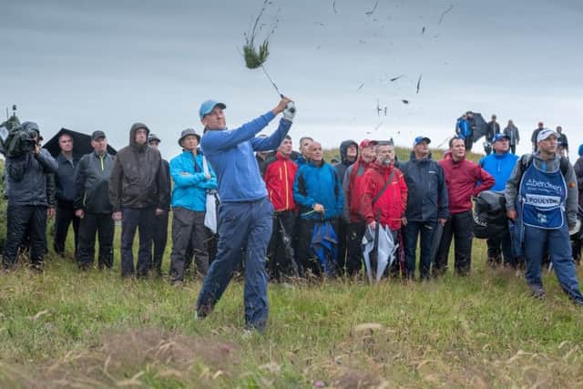 Battle-hardened: Ian Poulter defies the weather gods on the Ayrshire coast as he shares the lead. Photograph: Kenny Smith/SNS