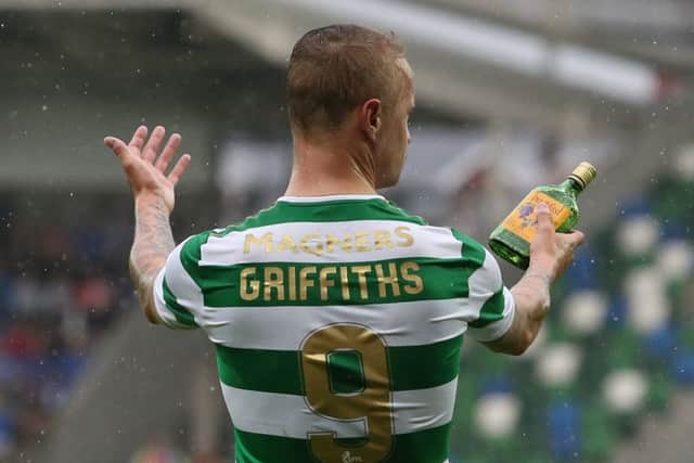 Leigh Griffiths holds a glass bottle thrown at him from the stands during the match against Linfield. Picture: PA