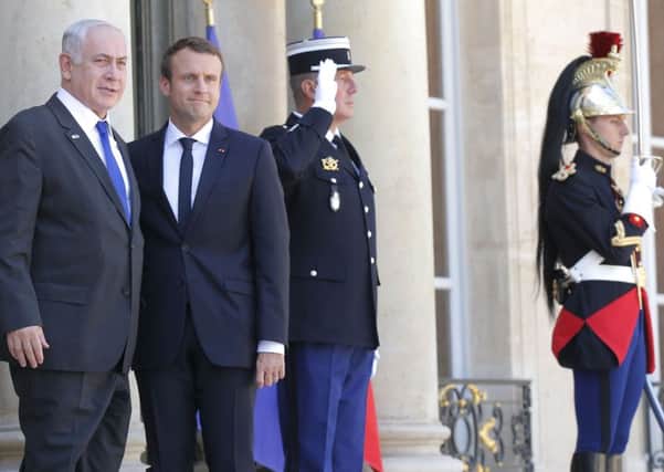 French President Emmanuel Macron (right) has denounced those who deny France's role in the Holocaust. Picture: AP Photo/Michel Euler