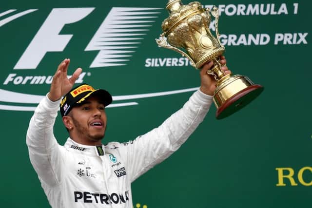 Mercedes' driver Lewis Hamilton celebrates with his trophy on the podium after the British Formula One Grand Prix at the Silverstone. Picture: Getty
