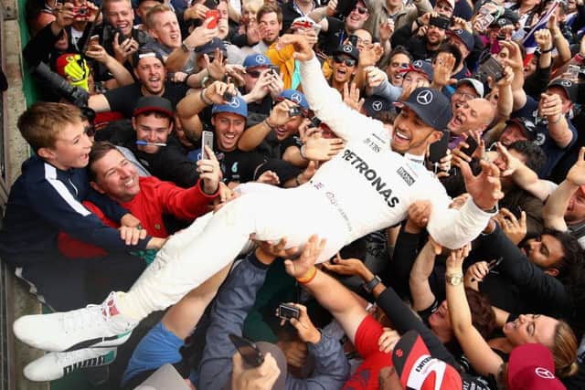 Race winner Lewis Hamilton celebrates with the fans after the British Grand Prix. Picture: Clive Mason/Getty Images
