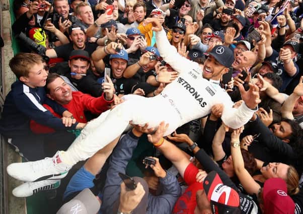 Race winner Lewis Hamilton celebrates with the fans after the British Grand Prix. Picture: Clive Mason/Getty Images