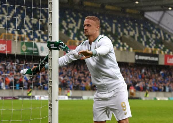 Leigh Griffiths tied a Celtic scarf around the post after full-time. Picture: Getty