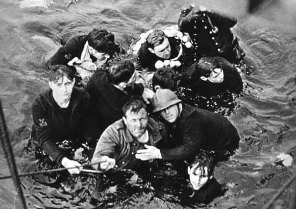Crew members of the French destroyer Bourrasque, sunk by mine at Dunkirk, are hauled aboard a British vessel from their sinking life-raft. Picture: Hulton Archive/Getty Images