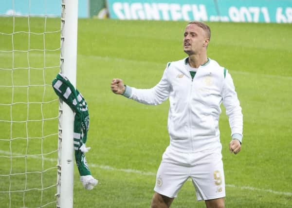 Leigh Griffiths after tying a Celtic scarf to the goal post following the win in Belfast. Picture: PA