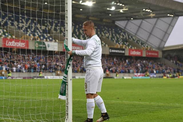 Leigh Griffiths ties a Celtic scarf on to the goalpost after his side's 2-0 win over Linfield. Picture: Getty