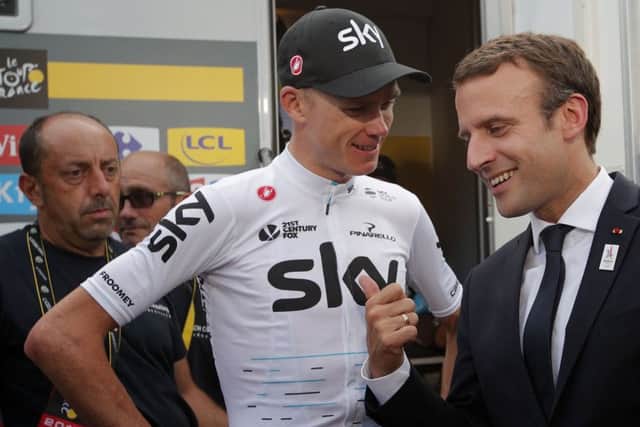 Chris Froome talks to French president Emmanuel Macron after extending his lead on stage 17.