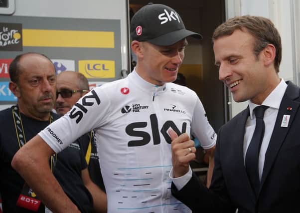 Chris Froome talks to French president Emmanuel Macron after extending his lead on stage 17.