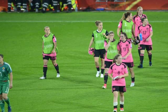 Dejected Scotland players go over to thank supporters after the defeat against England in Utrecht. Picture: Lorraine Hill.