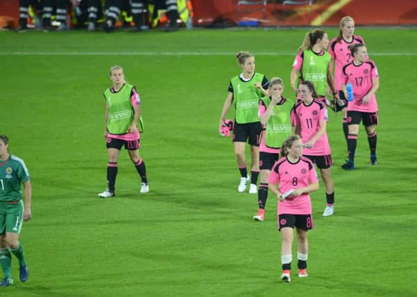 Dejected Scotland players go over to thank supporters after the defeat against England in Utrecht. Picture: Lorraine Hill.