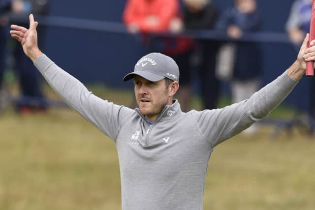 Stuart Manley celebrates on the 18th green after sinking his birdie putt during the Open first round. Picture Ian Rutherford