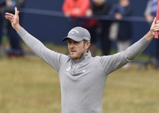 Stuart Manley celebrates on the 18th green after sinking his birdie putt during the Open first round. Picture Ian Rutherford