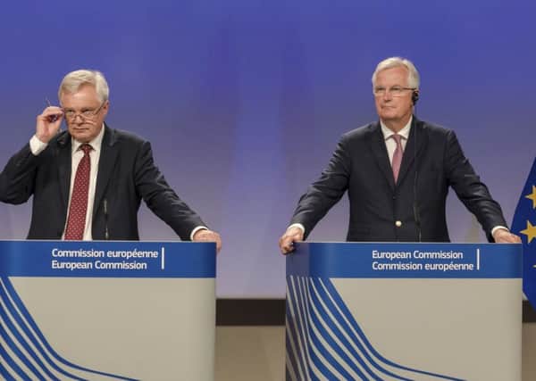 The EU chief Brexit negotiator Michel Barnier, right, and British Secretary of State David Davis address the media after a week of negotiations at EU headquarters in Brussels, Picture; AP