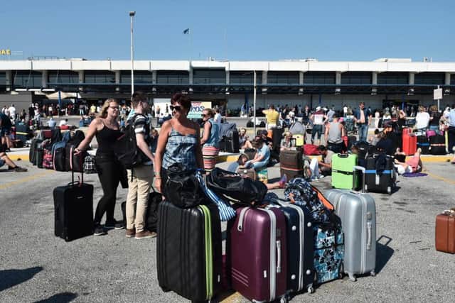 Tourists wait outside the terminal building at the airport on the Greek Island of Kos. Picture; Getty