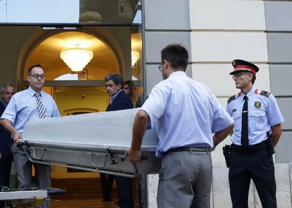 Workers bring a casket to the Dali Theatre Museum in Figueres.