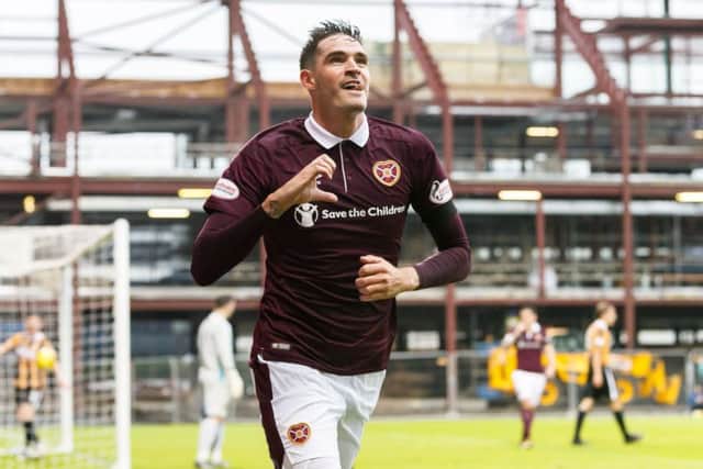 Hearts' Kyle Lafferty wheels away after heading the home side in front. Picture: SNS/Roddy Scott