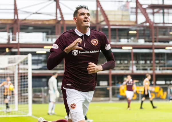 Hearts' Kyle Lafferty wheels away after heading the home side in front. Picture: SNS/Roddy Scott