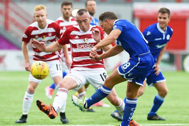 Hamilton's Darian MacKinnon battkes with Queen of the South's John Rankin. Picture: SNS/Craig Foy