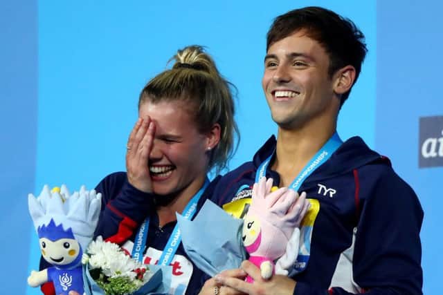 Edinburgh Diving Club's Grace Reid and Tom Daley collect their 3m mixed synchro silver medals. Picture: Clive Rose/Getty Images