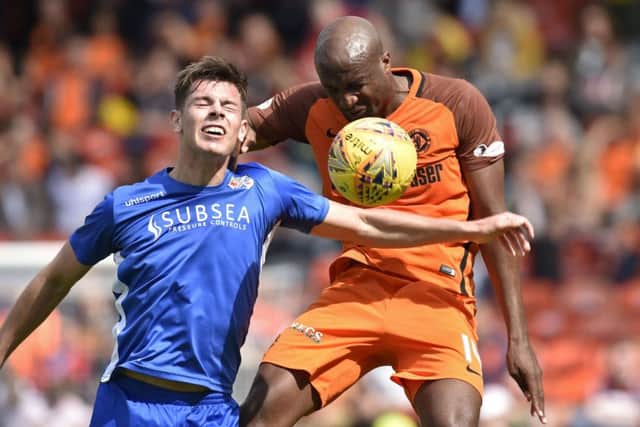 Dundee Uniteds William Edjenguele challenges Cameron Muirhead at Tannadice. Picture: Rob Casey..