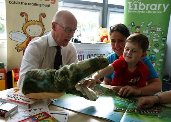 Deputy First Minister John Swinney plays with David Mckay and Library outreach worker Alison Nolan as he takes part in in a workshop at Newark Primary School, Port Glasgow. Picture: Andrew Milligan/PA Wire