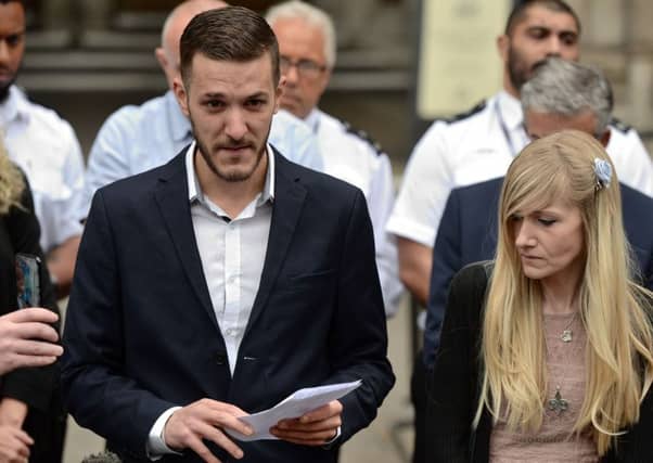 Chris Gard (L) reads out a statement while Charlie's mother Connie Yates (R) looks on. Picture: AFP/Getty Images