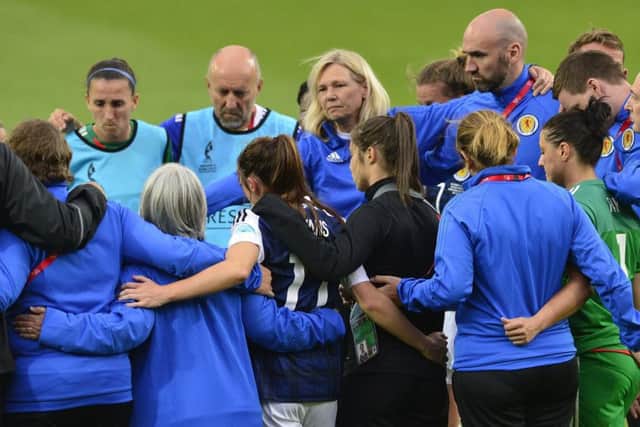 Anna Signeul and her players console themselves with a group hug following their defeat by Portugal. Picture: Lorraine Hill.