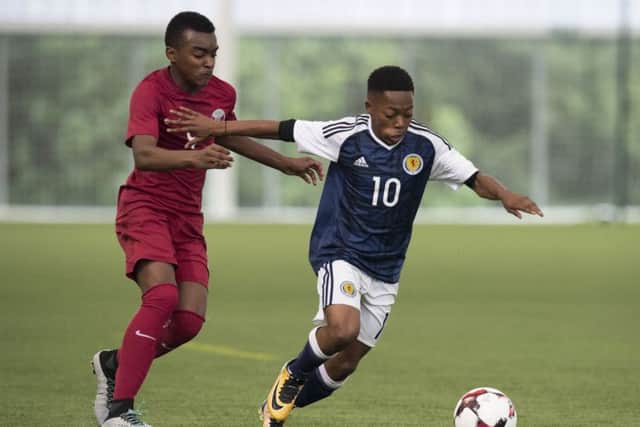Karamoko Dembele in action with Qatar's Abdulrahman Hassan AS Al-Abdulrahman. Picture: SNS/Ross Parker