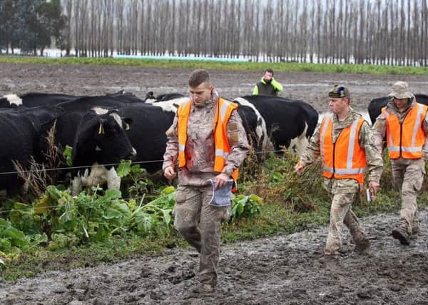 Corporal Cameron Ballard (centre), was one of eight men from the 4 Scots who helped with flood relief in Mosgiel.