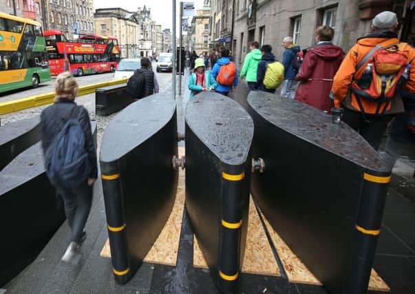 Newly-installed security barriers on the Royal Mile in Edinburgh which have been erected to prevent vehicles being driven into pedestrians by terrorists. PRESS ASSOCIATION Photo. Picture date: Wednesday July 26, 2017. The barriers are being deployed to provide security during the Edinburgh International Festival and Fringe.  See PA story POLICE Fringe. Photo credit should read: Jane Barlow/PA Wire