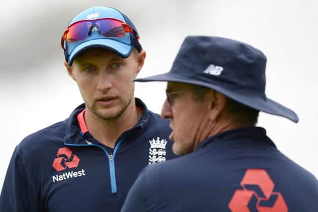 England captain Joe Root chats to coach Trevor Bayliss at a training session at the Oval. Picture: AFP/Getty Images