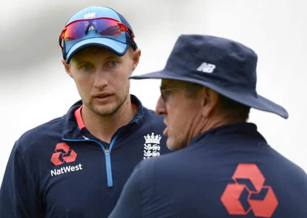 England captain Joe Root chats to coach Trevor Bayliss at a training session at the Oval. Picture: AFP/Getty Images