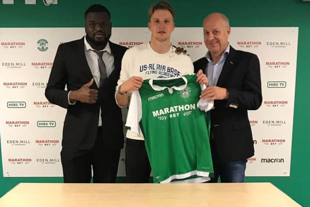 Vykintas Slivka with agents Prince Lamona, left, and ex-Dundee United star Freddy Van Der Hoorn. Picture: Contributed